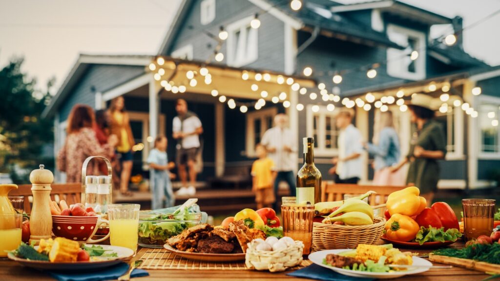 Table in backyard filled with foods and drinks
